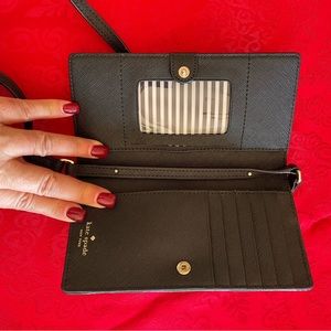 Kate Spade phone case/wallet. Never used. I think any size phone will fit.